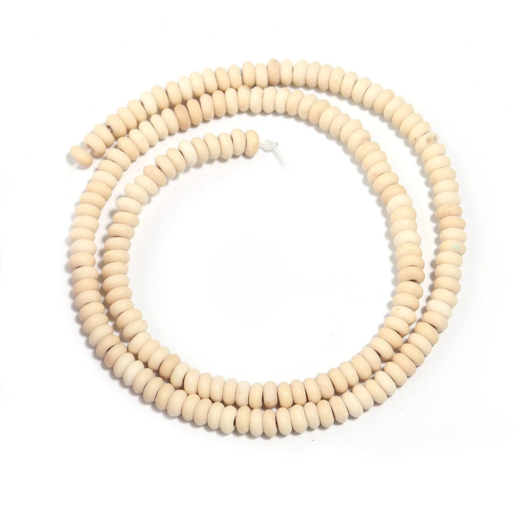 A strand of natural light beige stone beads used for jewelry making