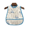 A white waterproof baby bib with a cartoon vehicle pattern hanging on a wooden hanger.
