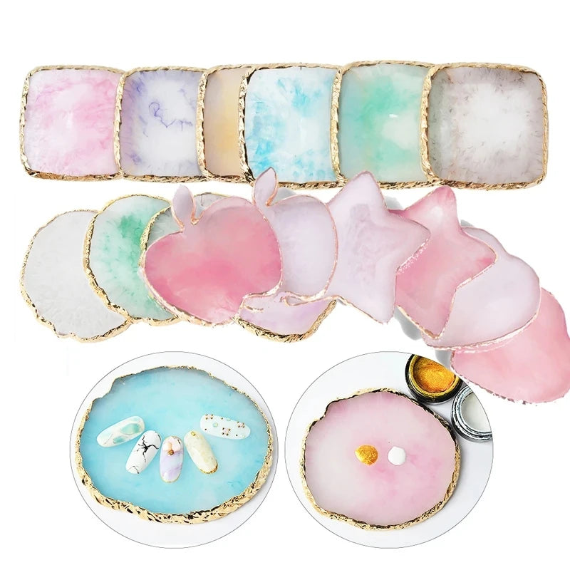 A collection of pink, blue, and white resin nail art palettes with gold trim.