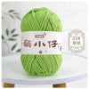 A ball of bright lime green chenille yarn labeled in Chinese characters for knitting and crochet.