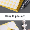 A stack of yellow round self-adhesive dot labels is shown being peeled off a sheet, demonstrating ease of use.