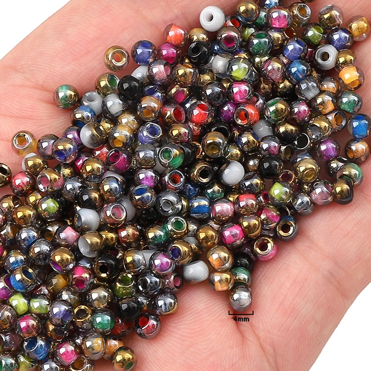 A handful of golden gradient glass beads in various colors and shades for DIY jewelry making