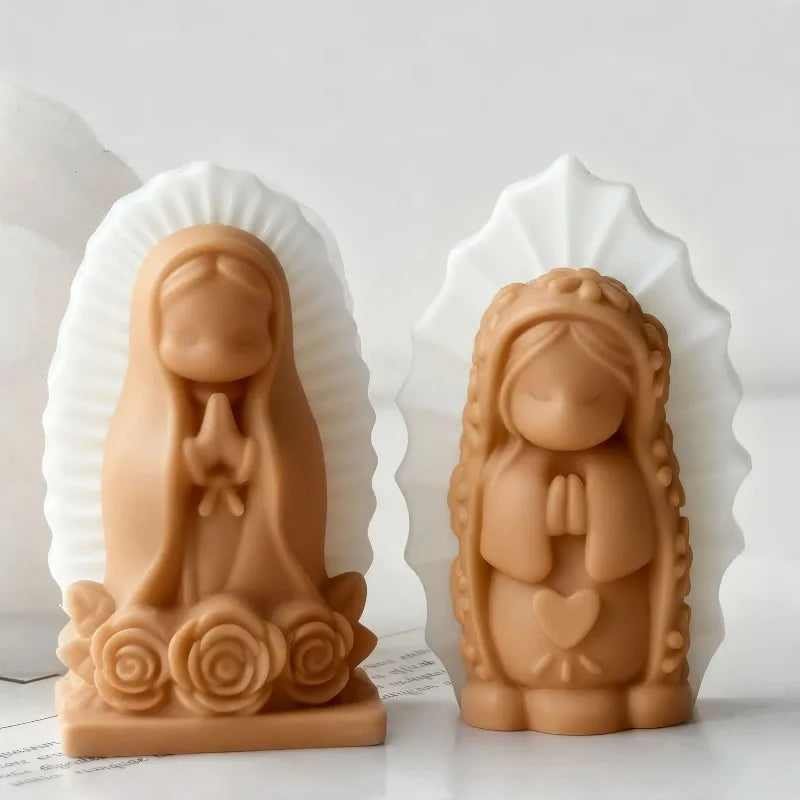 A pair of light brown silicone molds shaped like praying angel girls, set within white shell-like backgrounds.
