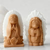 A pair of praying angel girl silicone molds in a matte tan color displayed against a white background.
