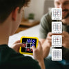 A person holds a yellow electronic tic tac toe game displaying various game icons and a flashing memory icon.