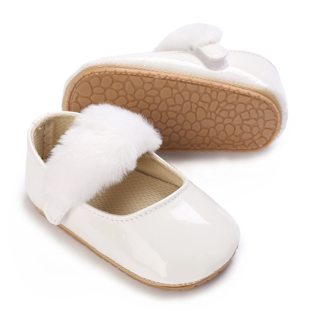White lace-trimmed baby girl moccasin shoes with a bow and a fluffy white trim