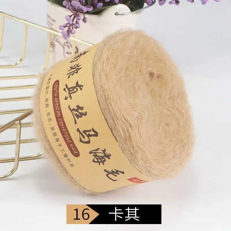 A ball of light beige silk mohair blended yarn labeled South African mohair for knitting.