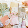 A collection of vintage paper sheets and cards featuring floral designs and soft pastel colors for journaling and scrapbookin