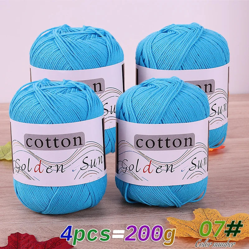 Four skeins of bright blue cotton knitting yarn for crochet and handmade projects