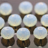 A collection of clear, round crystal glass beads used as spacers for jewelry making.