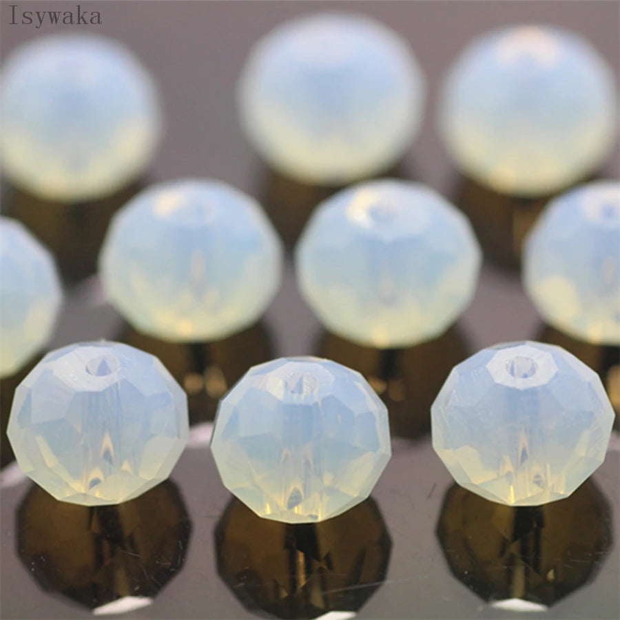 A collection of clear, round crystal glass beads used as spacers for jewelry making.