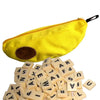 A yellow storage bag shaped like a banana with an avocado design, next to a pile of alphabet letter blocks.