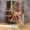 A painting by numbers kit showing an elegant woman portrait in pink dress sitting on a chair.