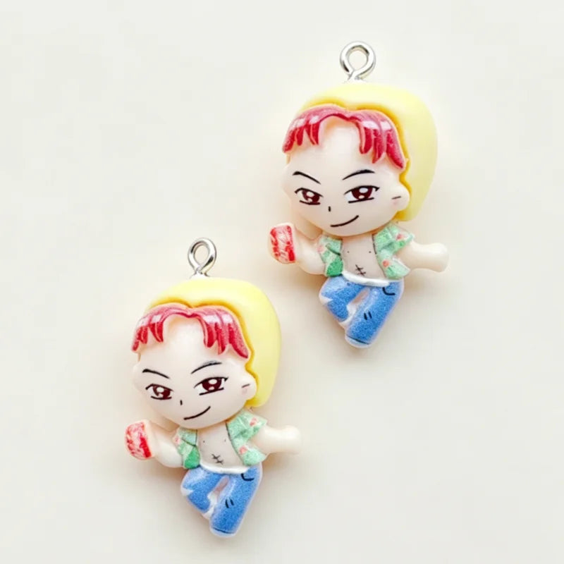 A set of 11 cartoon resin pendant charms featuring a smiling boy with red hair and yellow skin, dressed in a green shirt and 