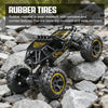 A black rubber tires off-road RC car is positioned on a rocky surface.
