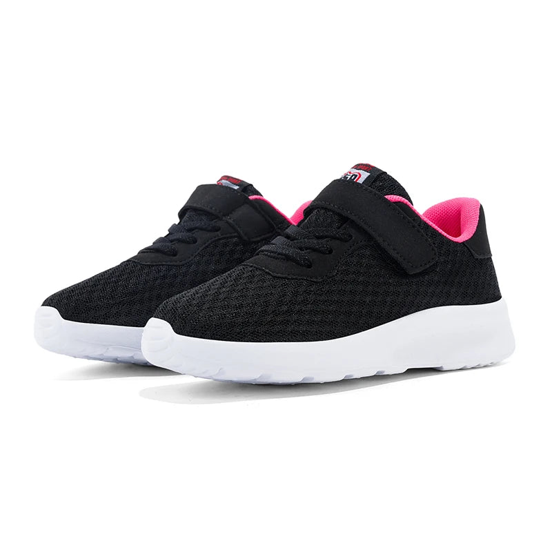 A pair of black breathable mesh kids' sneakers with pink accents shown from the side.