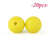 Two yellow silicone beads are shown against a white background.