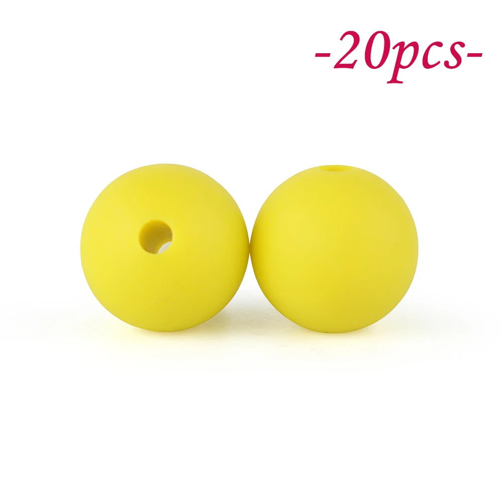 Two yellow silicone beads are shown against a white background.