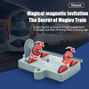A white train model demonstrates magnetic levitation using a physics kit with magnets and a track.