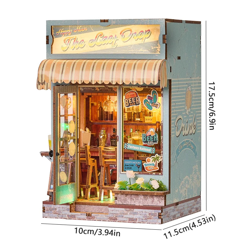 A miniature wooden dollhouse kit featuring a storefront with a striped awning and display items.