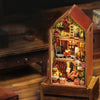 A wooden miniature dollhouse kit featuring a detailed diorama of a cozy, rustic interior with small figures and decorative el
