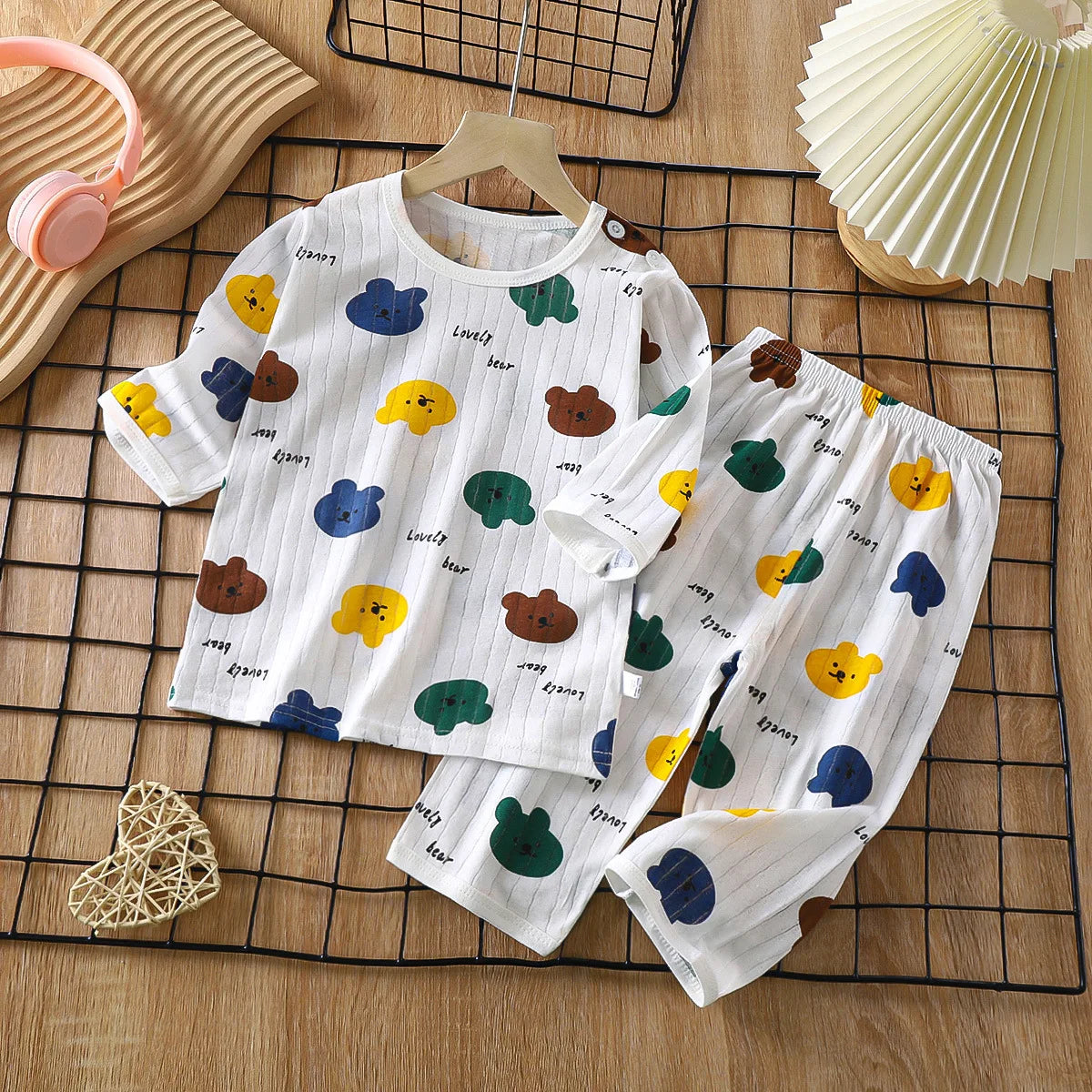 White long sleeve cotton pajama set for kids featuring a pattern of colorful fruit and animal shapes