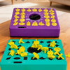 Un jeu de société violet chronométré et un jeu de société bleu sarcelle chronométré avec des pièces de puzzle jaunes sur une 