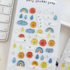 A sheet of white paper filled with various 3D smile face crystal stickers shaped like clouds, rainbows, and other cute elemen