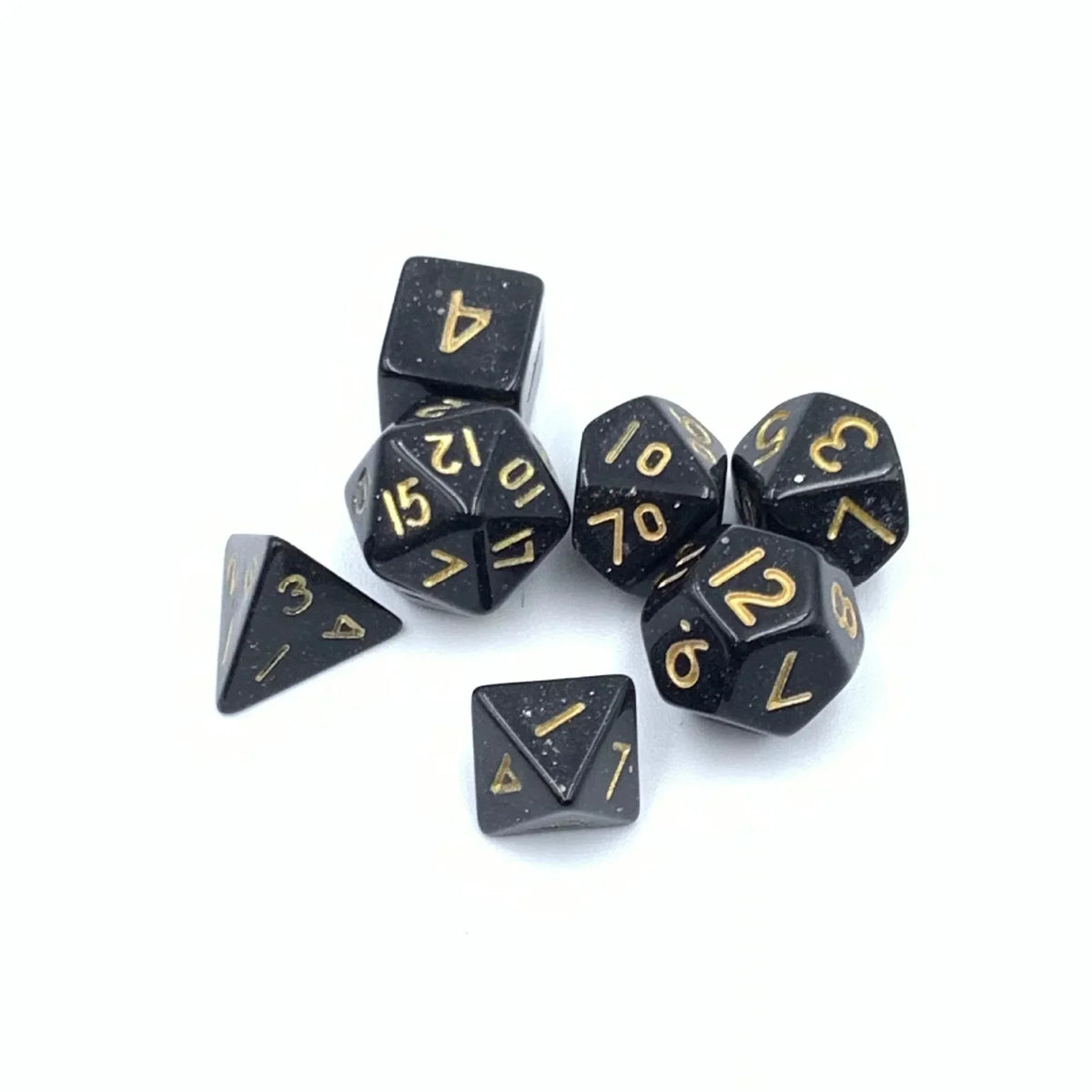 A set of seven black polyhedral dice showing various numbers and shapes.