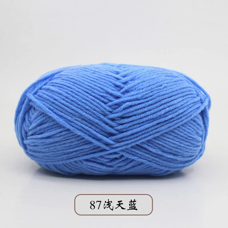 A ball of light blue pre-dyed milk cotton yarn used for knitting and crochet.