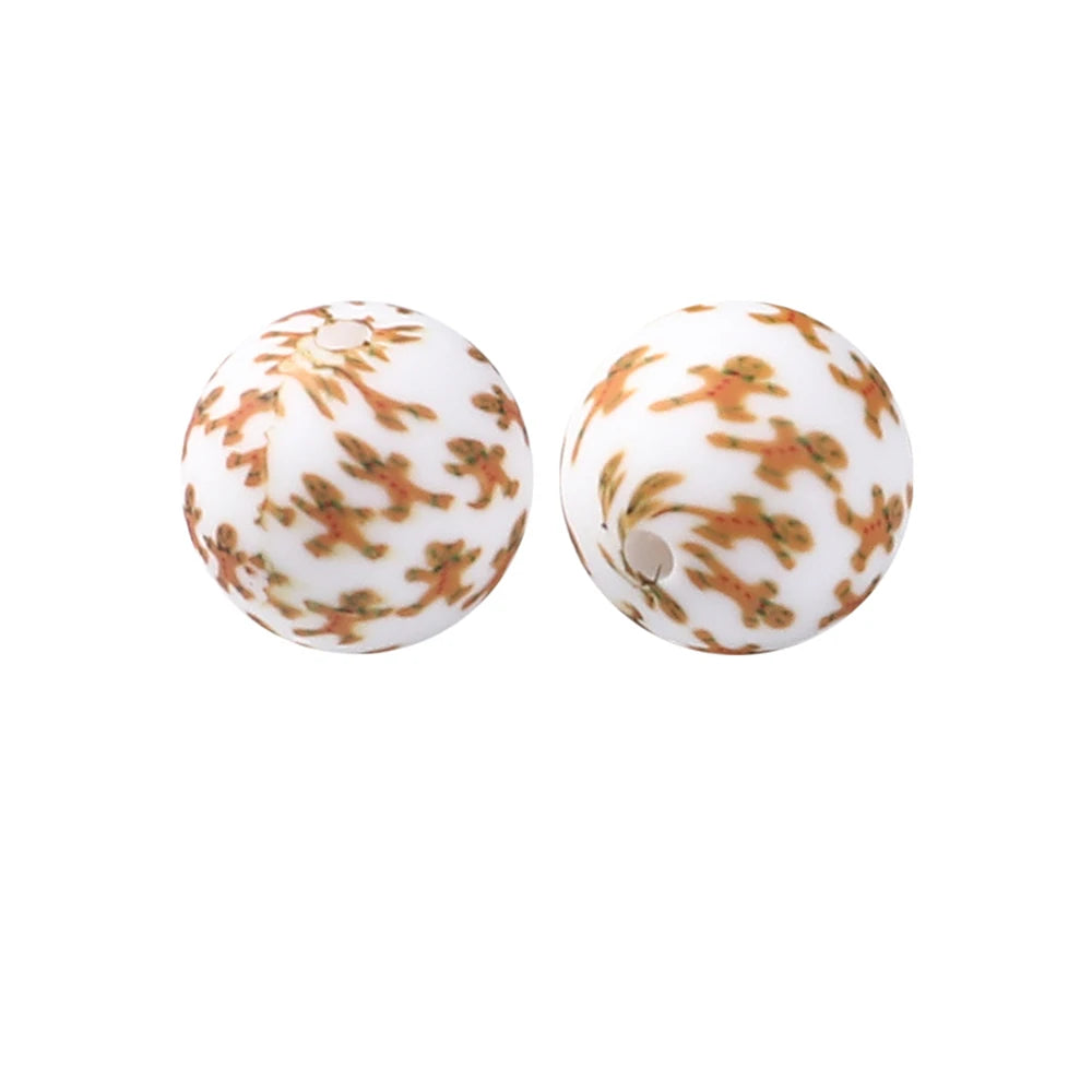 Pair of white silicone beads with an orange floral pattern for jewelry making