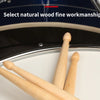 Close-up view of natural wood fine workmanship drumsticks resting on a drum surface.