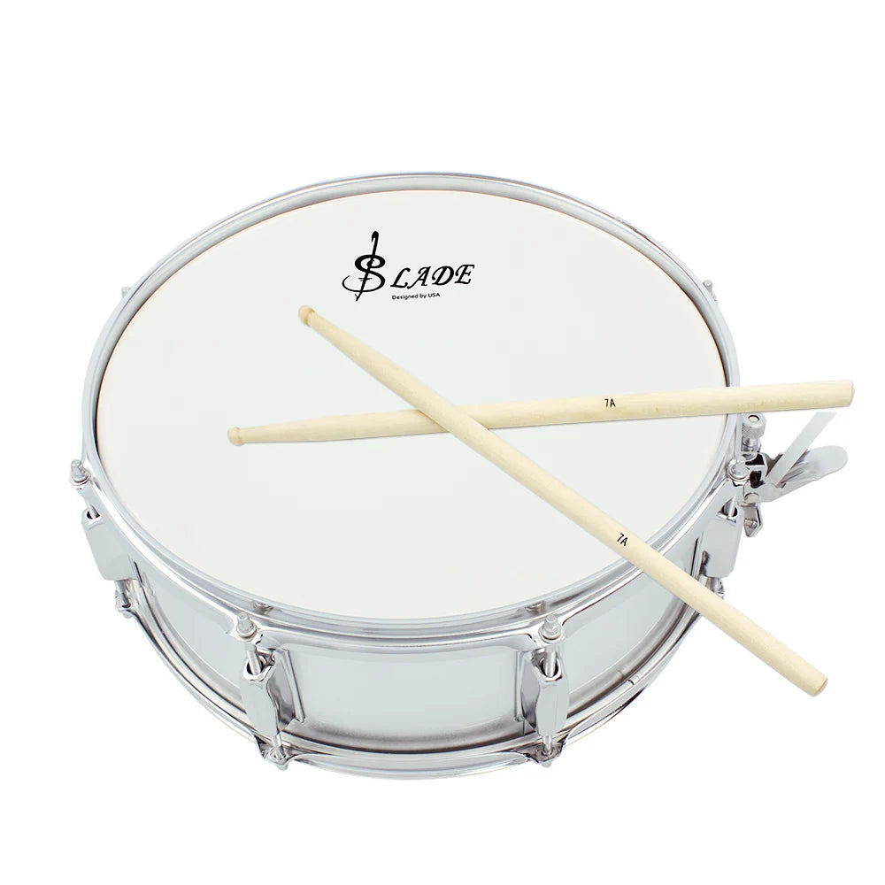 A silver drum with a white head and two maple wood drumsticks resting across the top.