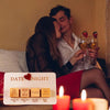 A wooden dice game set for a date night featuring tiles labeled Cook Dinner Watch a Movie Try a New Location and Sexy Time