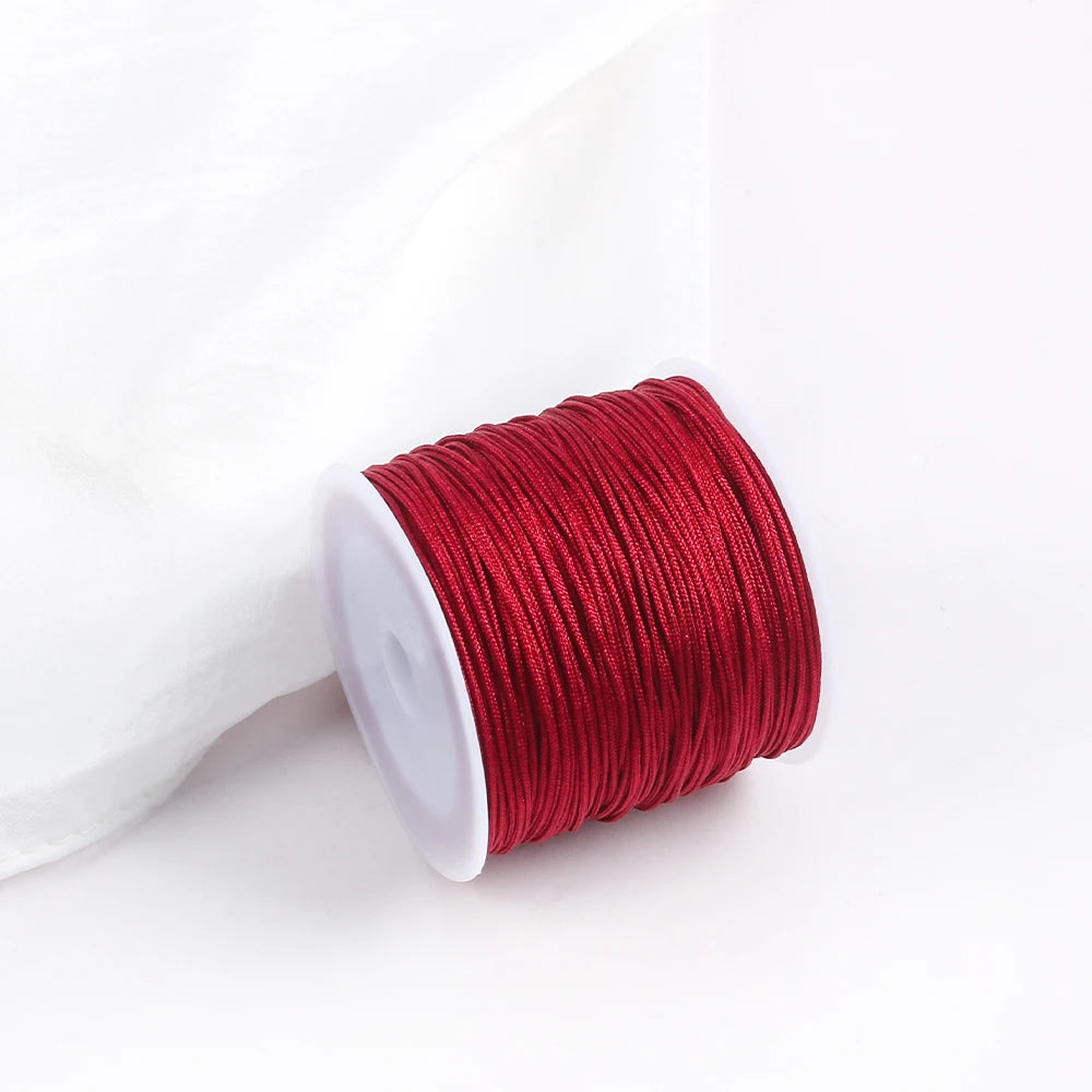 A roll of red macrame cord for jewelry making and crafts.