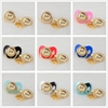 A set of personalized crystal pacifiers in various colors and styles with gold clips.