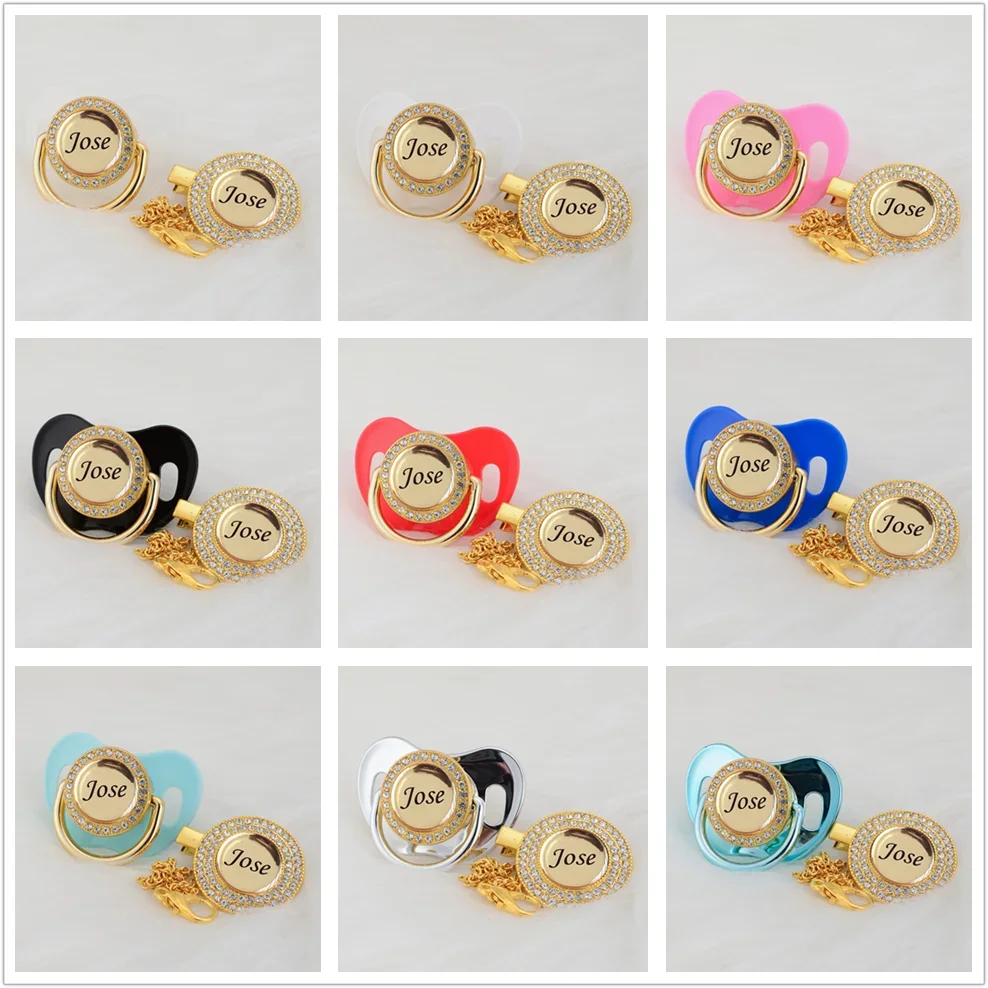 A set of personalized crystal pacifiers in various colors and styles with gold clips.