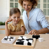 A woman and a girl are playing with a wooden 3D block puzzle cube on a table.