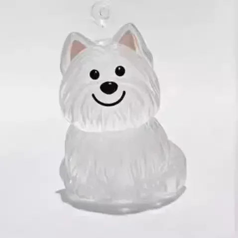A clear, dog-shaped pet hair keepsake keychain with floppy ears and a smiling expression.