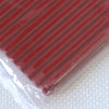 A close-up view of a red polymer clay kit with soft modeling clay packaged in clear plastic.