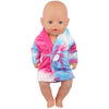 A baby doll wearing a pink and blue striped cartoon animal bathrobe set.