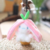 A pink and white plush toy shaped like a fruit bunny with green leaves