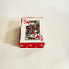 A red box containing a portable mini playing cards set featuring a King of Hearts design.