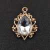 Gold plated water droplet charm featuring a clear crystal rhinestone set in an ornate flower design.