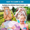 A girl is laughing while being sprayed with water from self-sealing water balloons outdoors.