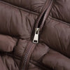 Close-up of a brown padded down vest showing the zipper and quilted texture.