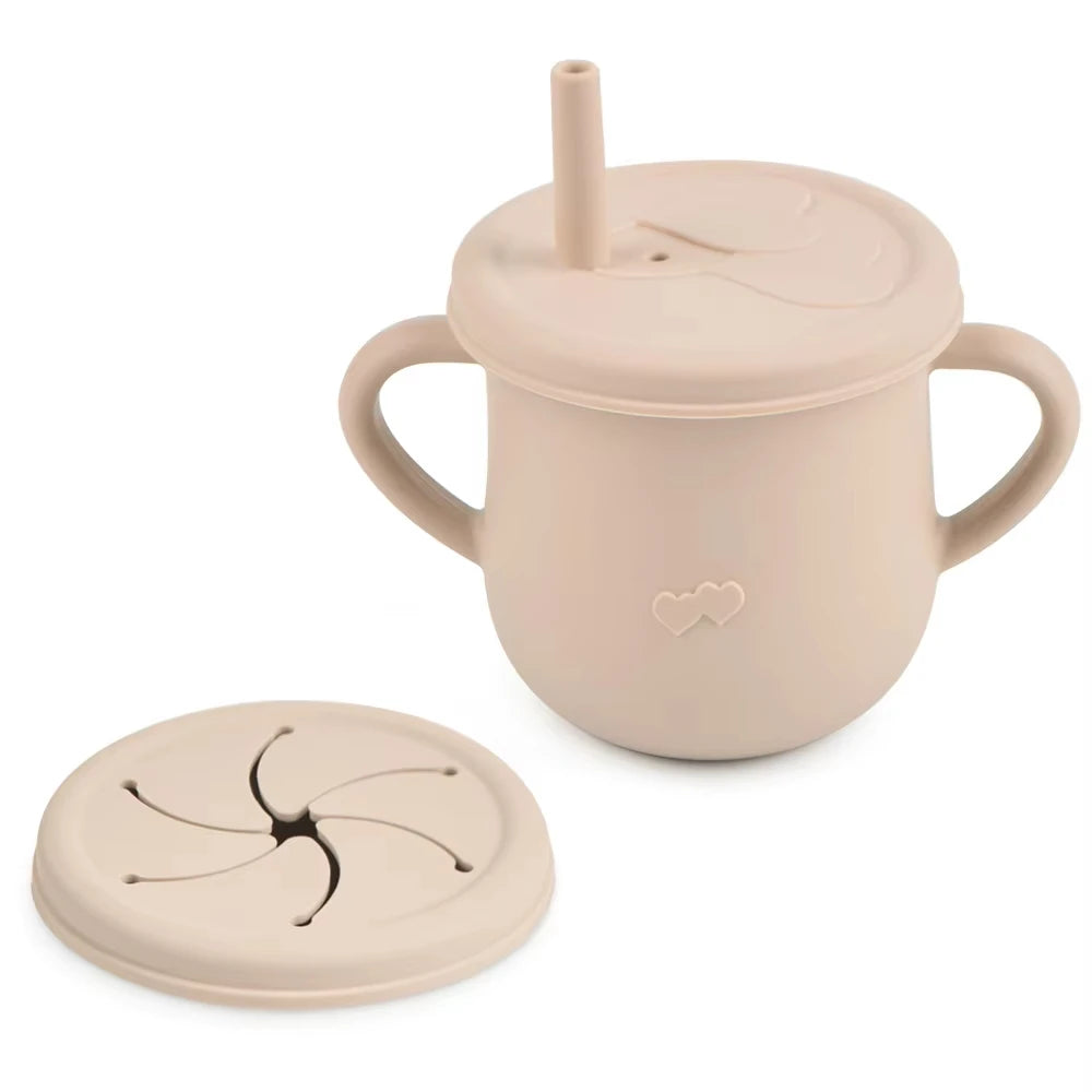 A light beige silicone snack cup with a lid and a small silicone plate is shown.