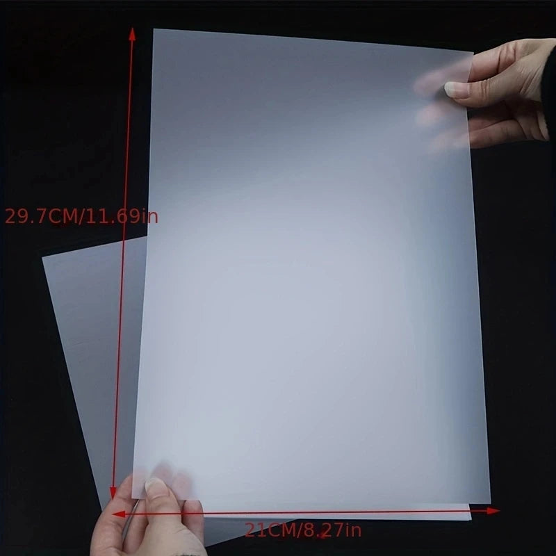 A sheet of white A4 DTF transfer film being measured by a hand, showing its dimensions.