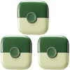 A close-up view of a green and cream 2-in-1 baby hair cutting comb with dual-edge blades.