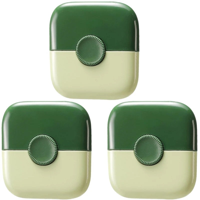 A close-up view of a green and cream 2-in-1 baby hair cutting comb with dual-edge blades.